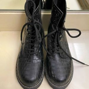 Faux snakeskin combat boots.